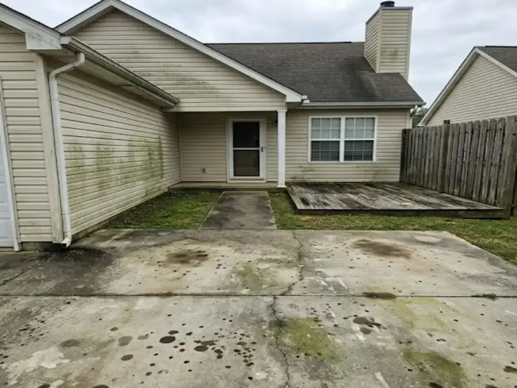 Before roof cleaning — black streaks and algae visible